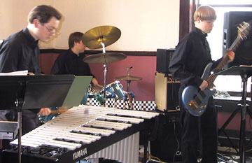 2004 performance in all black concert dress with vibraphone, drum set and bass guitar